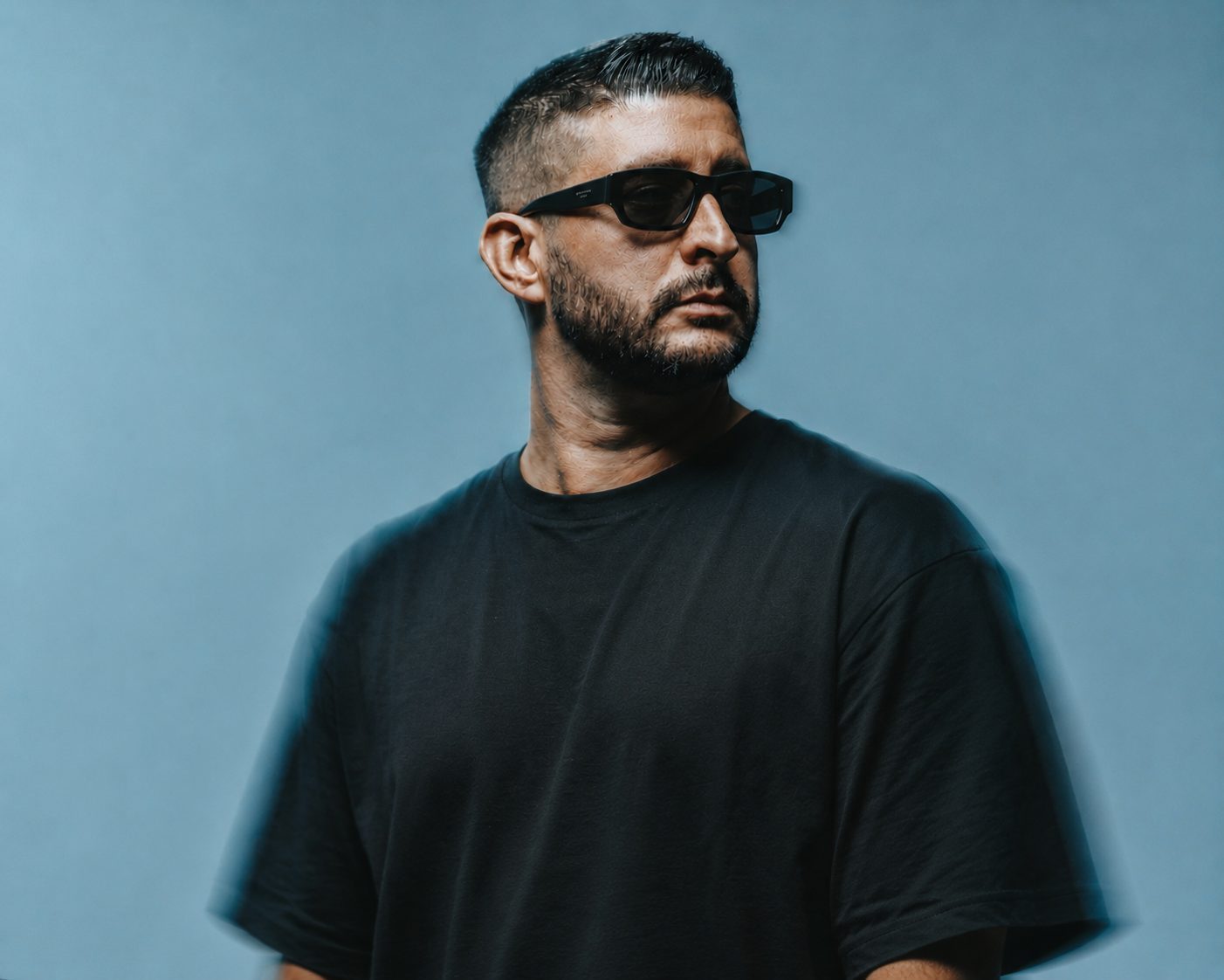 Press portrait of Martin OCCO against a blue backdrop